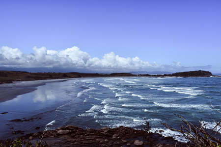 A view of a beach with rolling wavesの写真素材