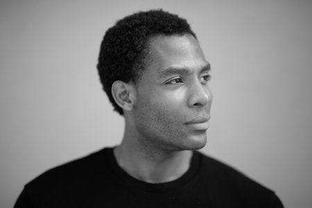 Black and white close-up portrait of a man looking to the side with a thoughtful expressionの写真素材