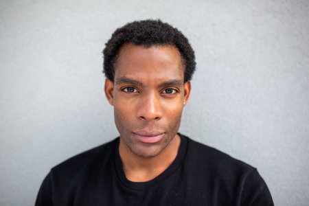 Close-up portrait of a man with a neutral expression, looking directly at the cameraの写真素材