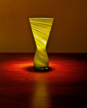 A glass vase on a table top.の写真素材