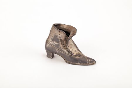 A very old ornate pewter boot.の写真素材