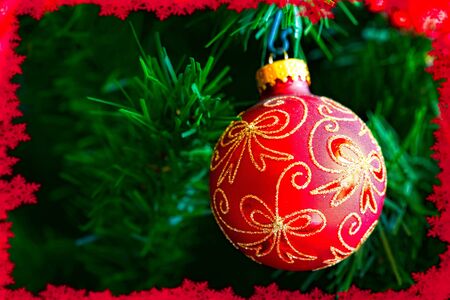 A christmas  ball on a tree with a red border.の写真素材