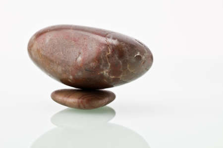 A large pebble sitting on a small pebble.の写真素材