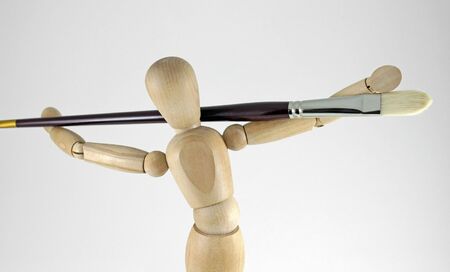 Closeup of artist manikin and artist brushの写真素材