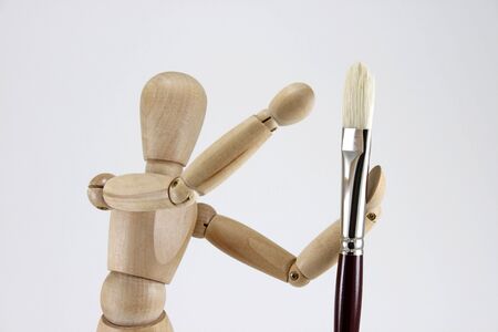 Closeup of artist manikin and artist brushの写真素材