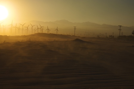 Windmills and Blowing Sand at Sunset near Palm Springs, CAの写真素材