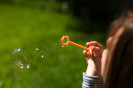 A beautiful girl blowing bubbles