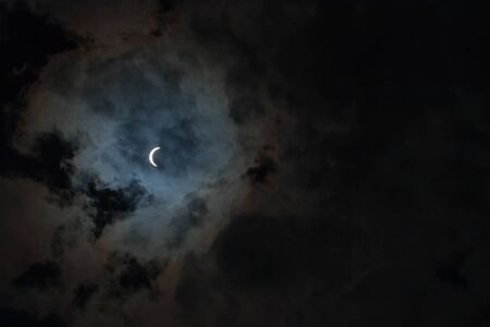 Solar Eclipse with Cloudsの写真素材