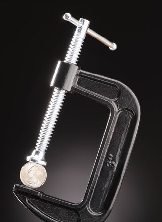 Black C-Clamp Holding a U.S. Quarterの写真素材