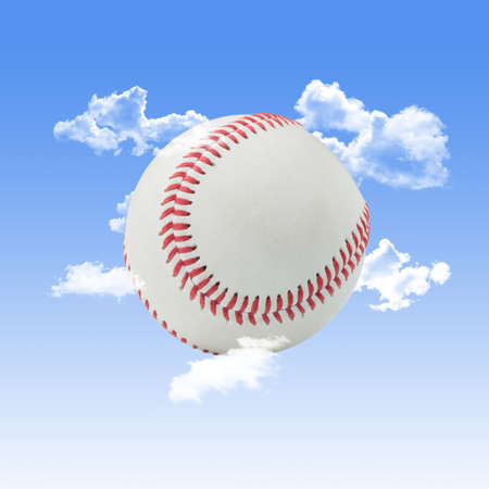 Baseball with Clouds and a Blue Sky Backgroundの写真素材