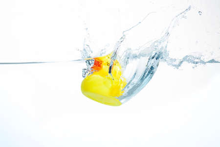 Yellow Rubber Duck Splashing into Water with a White Background