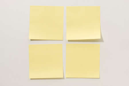Yellow Sticky Notes Lined up on a White Backgroundの写真素材