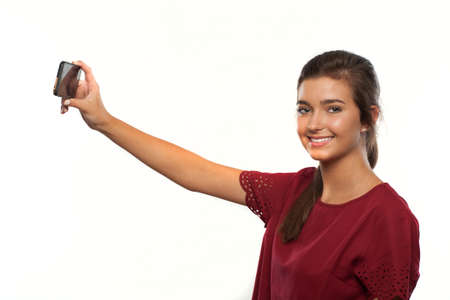 Teenage Girl with a Smart Phone Taking a Selfie of Herselfの写真素材