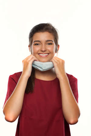 Teenage Girl Wearing a Surgical Mask for Protection During a Virus Pandemicの写真素材