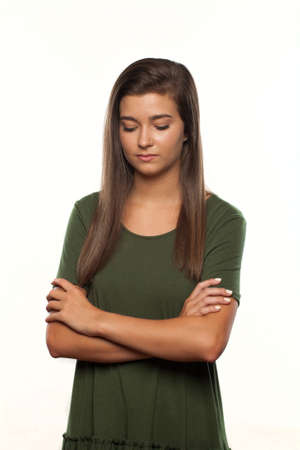 Sad or Depressed Teenage Girl with Her Arms folded and Her here down.の写真素材
