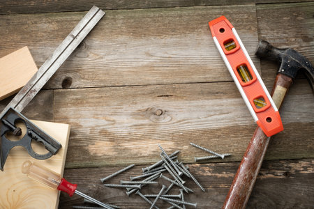 Rustic Wooden Bacground with Common Tools Around the Edges with Room for Textの写真素材