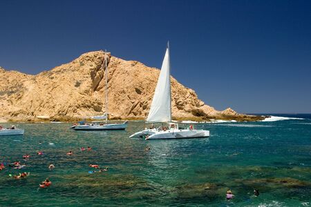 Tropical Mexican Cove with Sailboats and people snorkelingの写真素材
