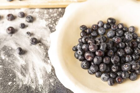 a fresh blueberry pie in the process of being baked.の写真素材