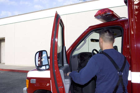 firefighter opening ambulance door to leave hospitalの写真素材