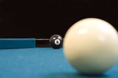 aiming for the 8 ball in the corner pocket to winの写真素材
