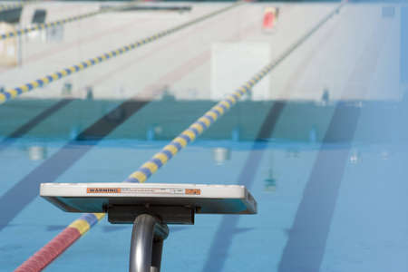 diving board for competitive swimming overlooking the poolの写真素材