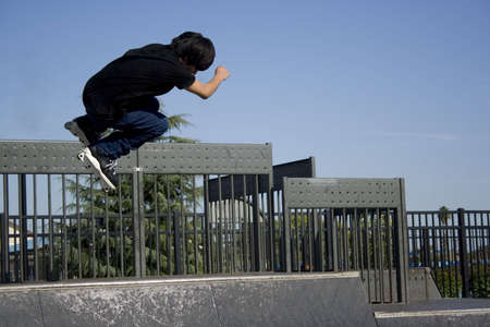 inline skater midair off the lip of a halfpipeの写真素材