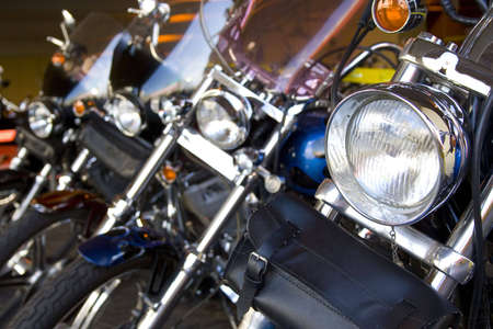 motorcycle headlights lined up with selective focus on first headlightの写真素材