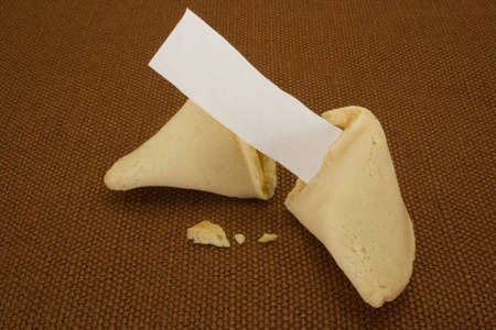 open fortune cookie with blank paper for your message/copyの写真素材