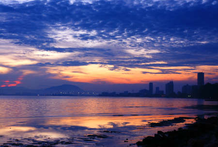 City skyline at the beach during nightfall.の写真素材