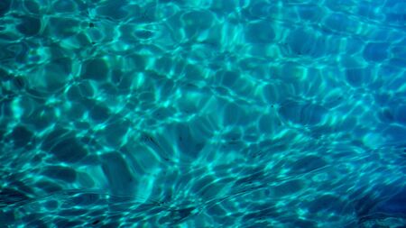 Clear blue turquoise colored ocean sea water ripple background texture.の写真素材