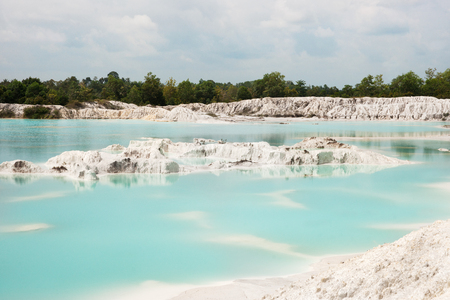 Man-made artificial lake Kaolin, turned from a mining ground holes. Land contains kaolinite and is white. Due to mining, holes were formed. and were covered by rain water, forming a clear blue lake, Air Raya Village, Tanjung Pandan, Belitung Island.の写真素材