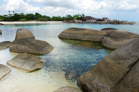 Natural rock formation in the sea and on a white sand beach in Belitung Island in the morning, Indonesia.の写真素材