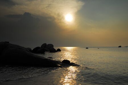 Natural rock formation at the coast on white sand beach in Belitung Island during sunset, Indonesia.の写真素材