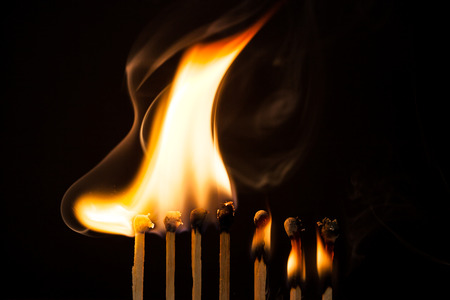Burning matches on black backgroundの写真素材