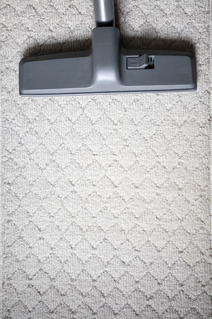 Head of Vacuum cleaner on carpet from top viewの写真素材