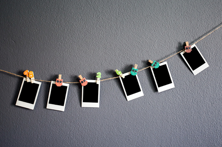 hanging photo frame on gray wallの写真素材