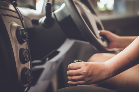 woman shifting gears on gearbox in carの写真素材