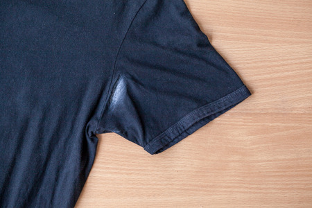 Shirts dirty caused by roll- on deodorant on wooden backgroundの写真素材