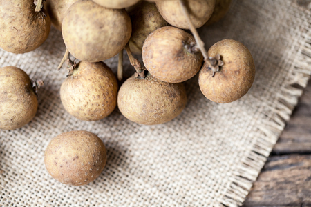 Fresh longan fruits on a wooden backgroundの写真素材