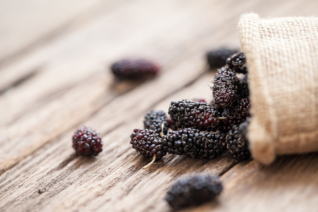 fresh organic mulberries on wooden backgroundの写真素材