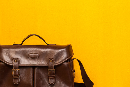 leather bag on yellow wall backgroundの写真素材