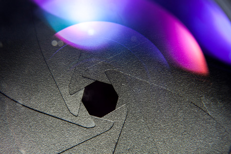 vintage lens aperture close up with color flaresの写真素材