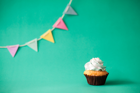 Birthday cupcake on green backgroundの写真素材