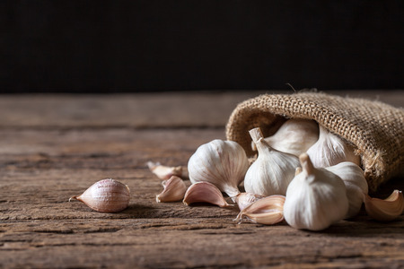 Garlic cloves and bulb on wooden backgroundの写真素材