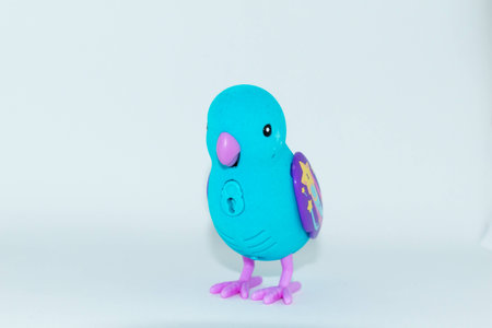Blue bird with beak and purple wings toy with white backgroundの写真素材