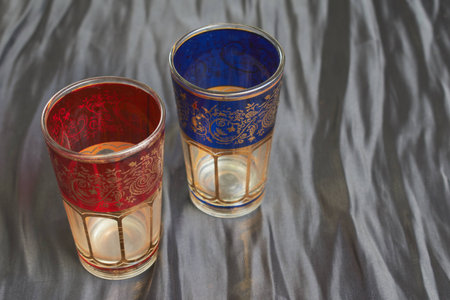 Traditional decorated glasses to drink turkish tea to guests in Morocco on dark backgroundの写真素材