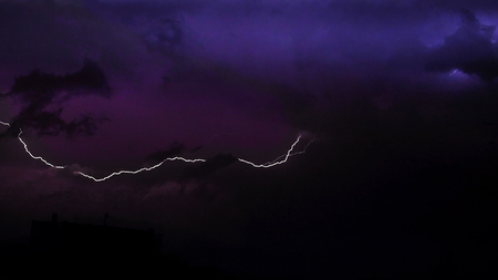 Stunning lightning in the dark sky in the stormの写真素材