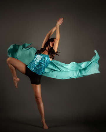 Dancer posing with a flying cloth making the figure of a butterflyの写真素材