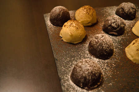 Dark and white chocolate bonbons filled with raspberry and coconutの写真素材