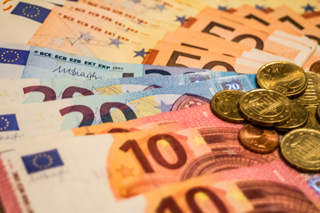 A composition of euro banknotes and coins providing great options to be used for illustrating subjects as business, banking, media, presentations etc., as well as for money related blogs or article featuresの写真素材